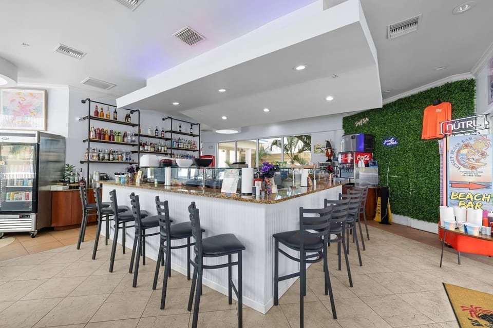 The stylish bar awaits you, serving cool drinks and a vibrant atmosphere to enjoy with friends.