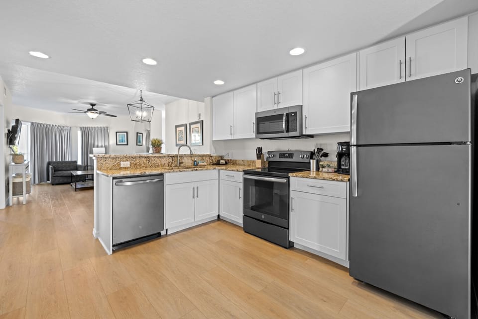 Cook with ease in a streamlined kitchen, showcasing modern appliances and elegant granite countertops.