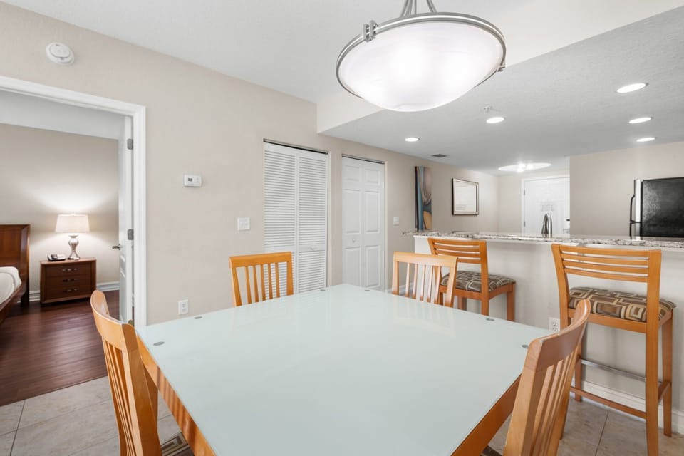 Gather around the glass-top dining table for a meal or game night in this cozy space.