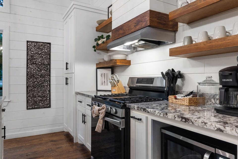 Enjoy a fully equipped space with a gas stove, Keurig, drip coffee maker, cookware, wine glasses, utensils, and everything needed for slow breakfasts and cozy cabin dinners.