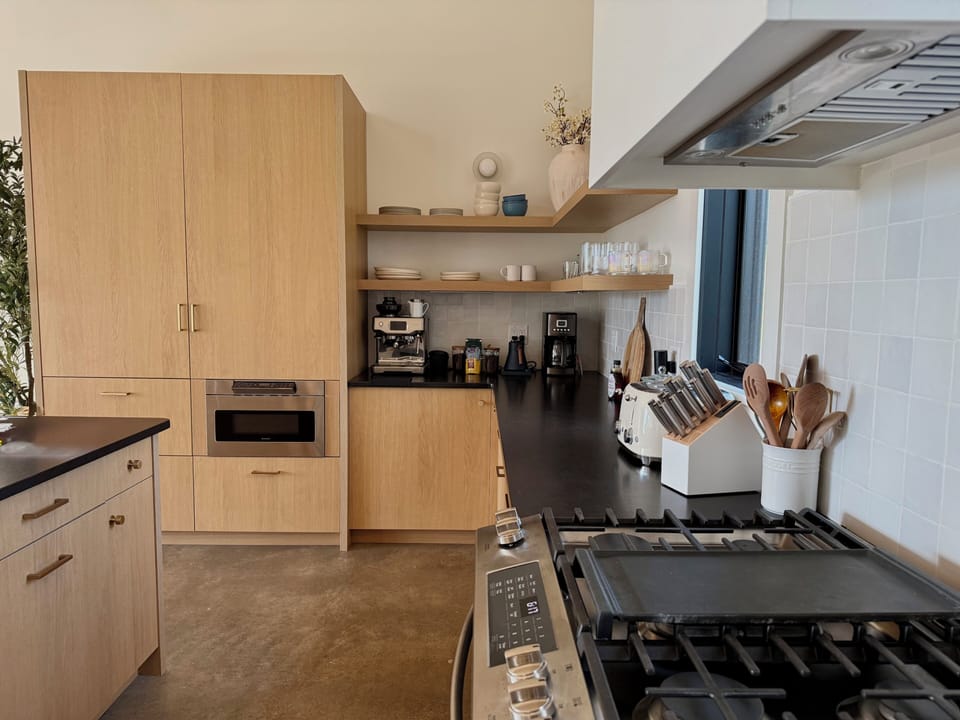 Modern chef’s kitchen with gas range, coffee station, and sleek finishes