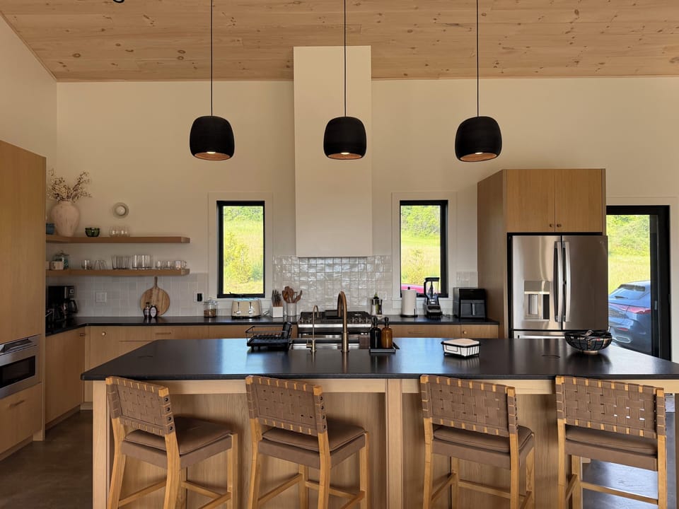 Bright modern kitchen with large island seating and warm wood finishes