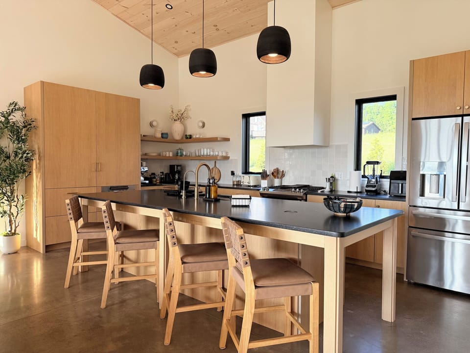 Bright modern kitchen with oversized island seating and designer finishes