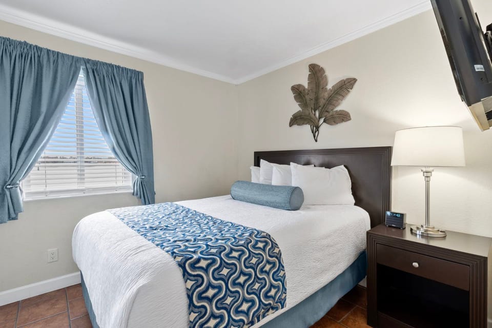 Embrace soft light and soothing colors in this cozy bedroom, a perfect spot for a restful night's sleep.