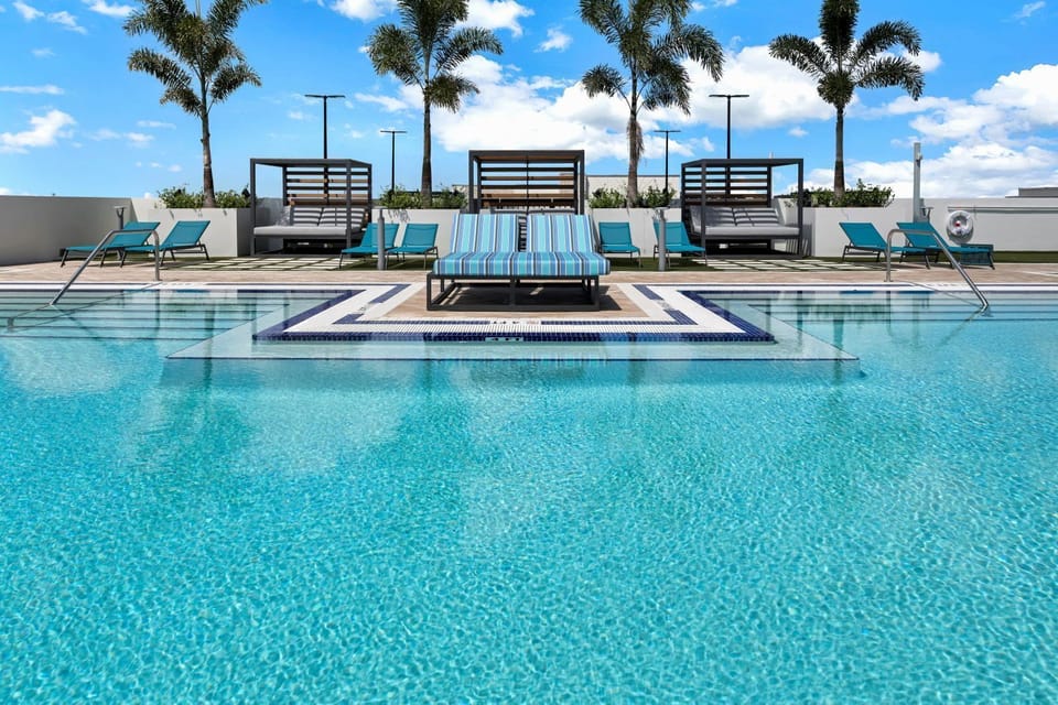 Unwind in a vibrant atmosphere where comfort meets style, near inviting cabanas and crystal-clear waters.