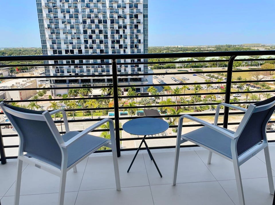 Sip your morning coffee on the balcony, enjoying partial views and fresh air in a relaxing setting.