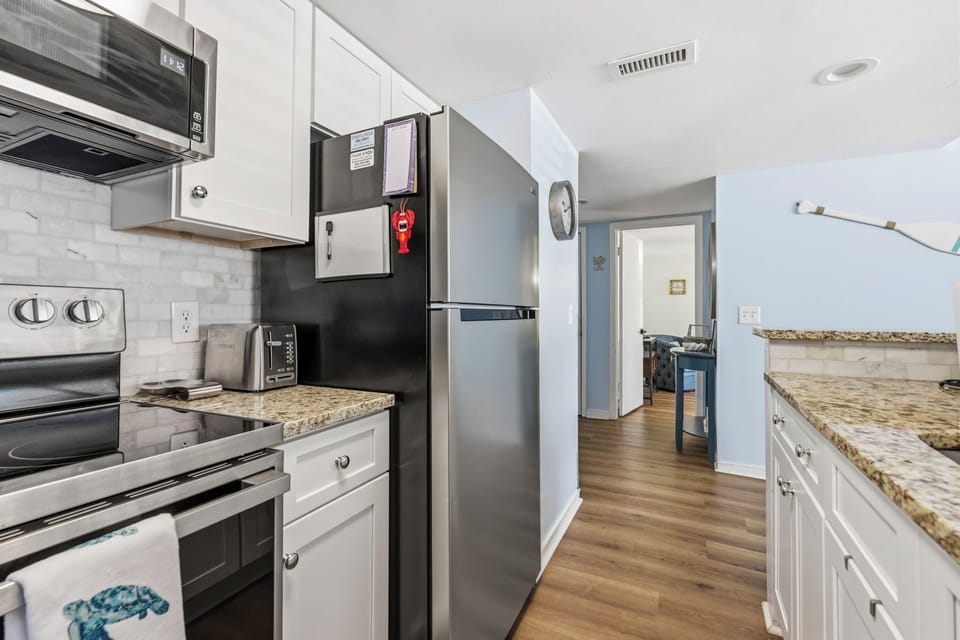Full kitchen with stainless steel appliances and granite countertops