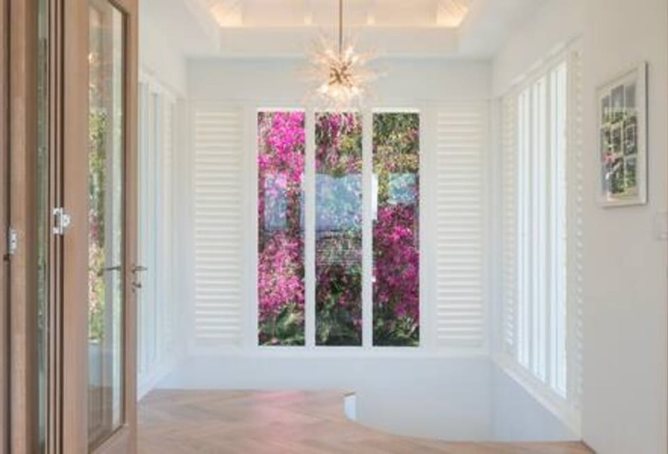 Informal living room on the upper floor ensures stunning views of the pool, garden and ocean beyond.