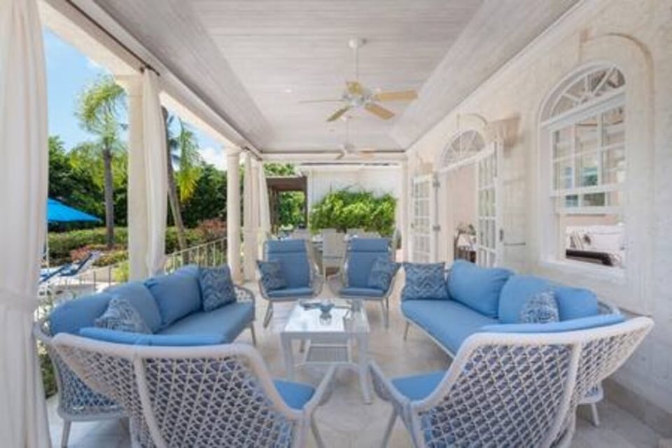 Outdoor seating for guests to relax and socialise whilst soaking in the pool and garden view.