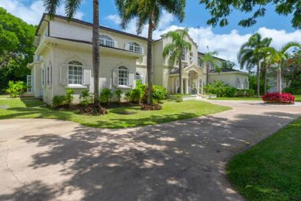 The grand entrance to Saramanda within the Sandy Lane estate features and impressive driveway with security gates and a large driveway.