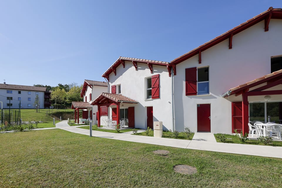 Your two-bedroom apartment is nestled within the iconic red-and-white Basque architecture of Le Domaine d'Uhaina, steps away from the pools and resort facilities.