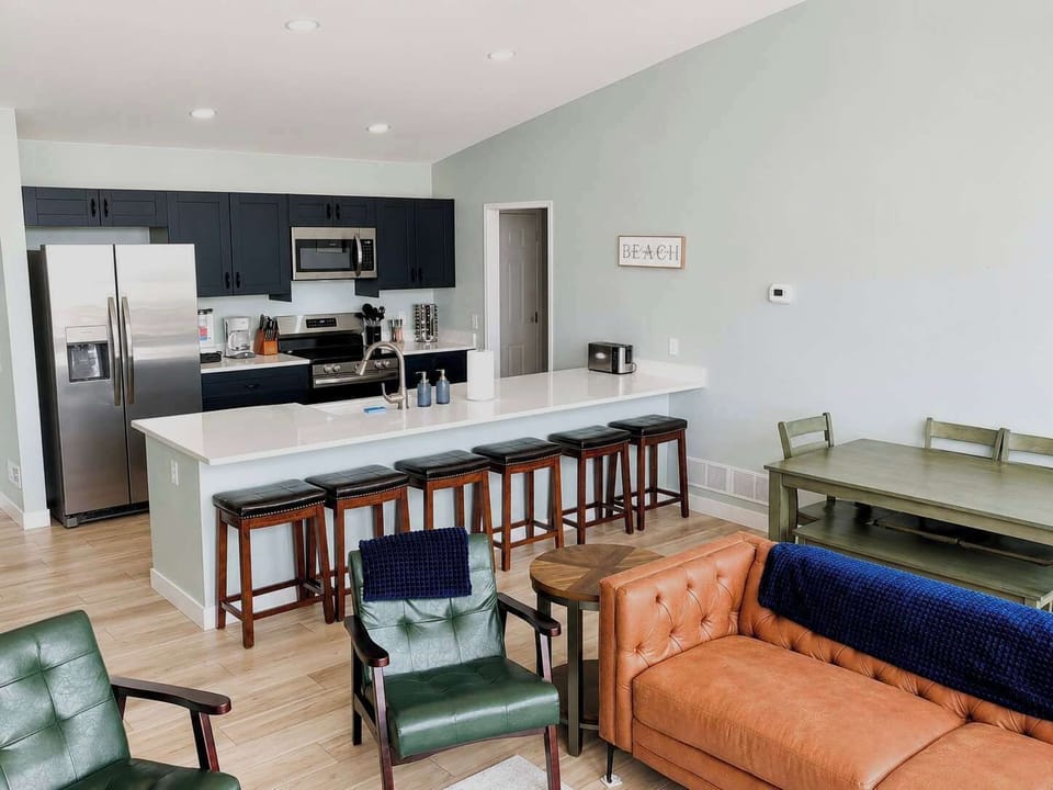The upper level kitchen and living room are an open concept floorplan allowing everyone in your party to spend time together when cooking.