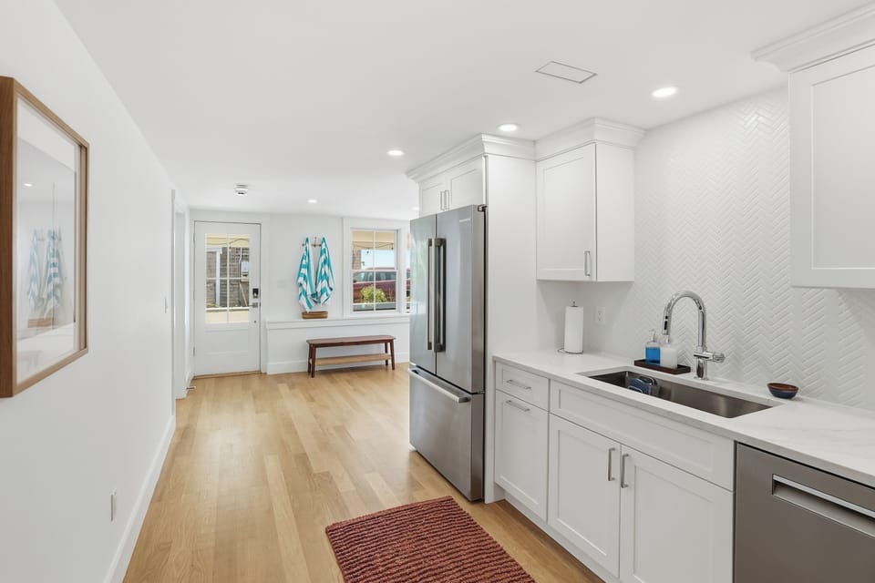 Modern kitchen with stainless appliances and airy coastal style