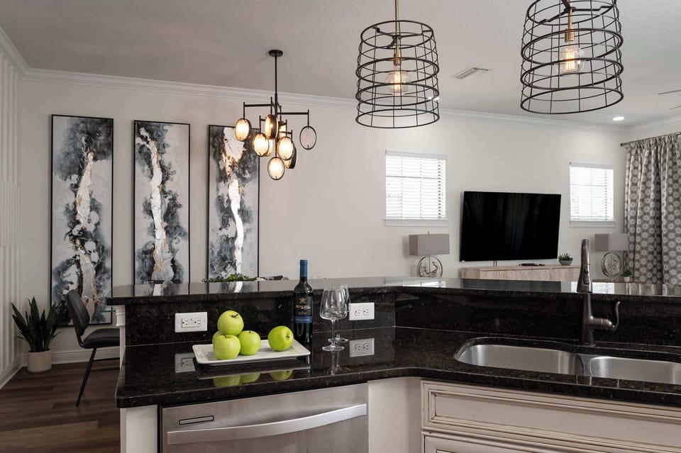 Modern kitchen island with granite countertops and unique pendant lighting