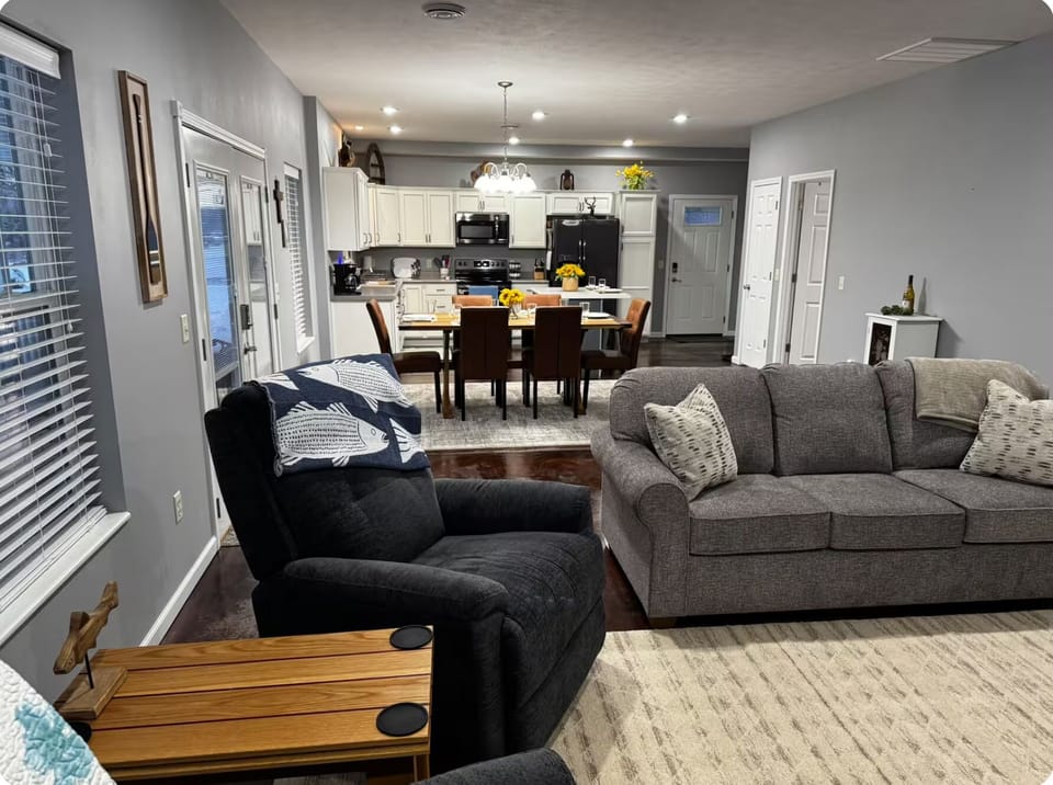 Spacious living room with comfortable seating, TV, fireplace, and sleeper sofa.
