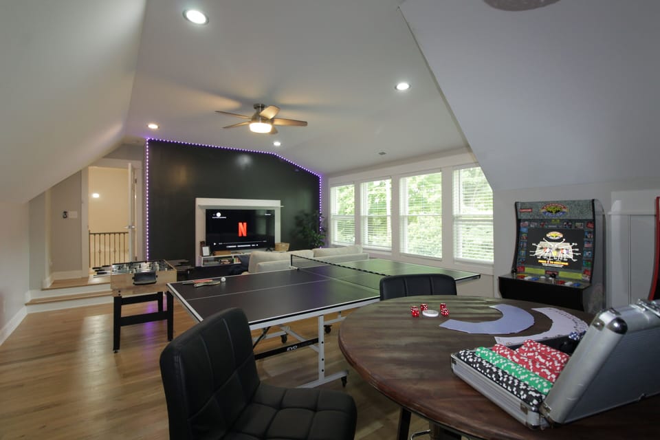 Game room with a natural light and a ping pong table.