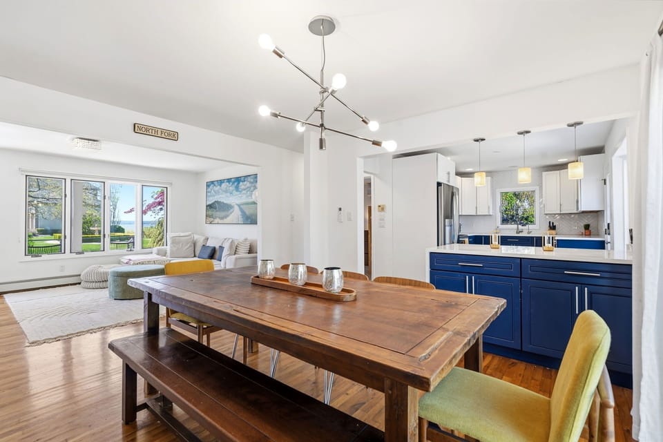 Open-plan dining and kitchen with partial bay view from the living area