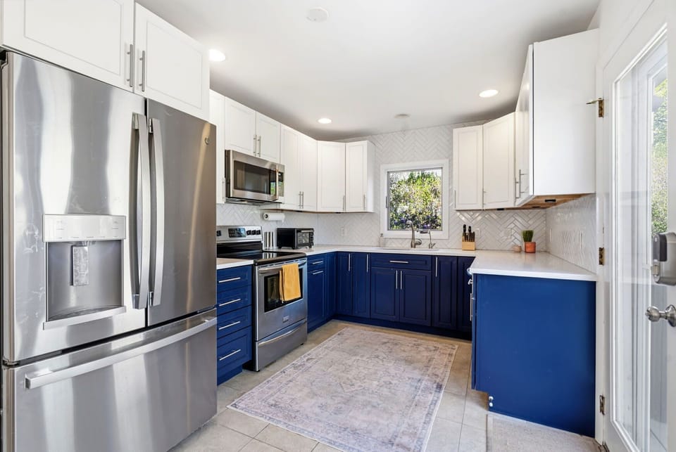 Kitchen with stainless French-door refrigerator and electric range
