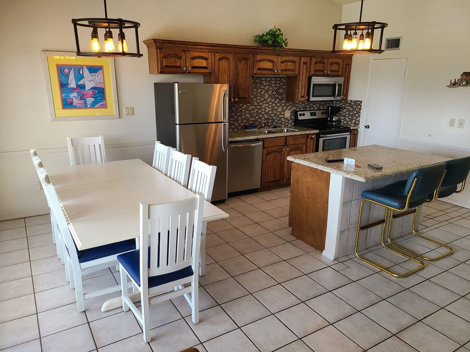 Dining room table is just off the kitchen. Open the blinds to courtyard view.