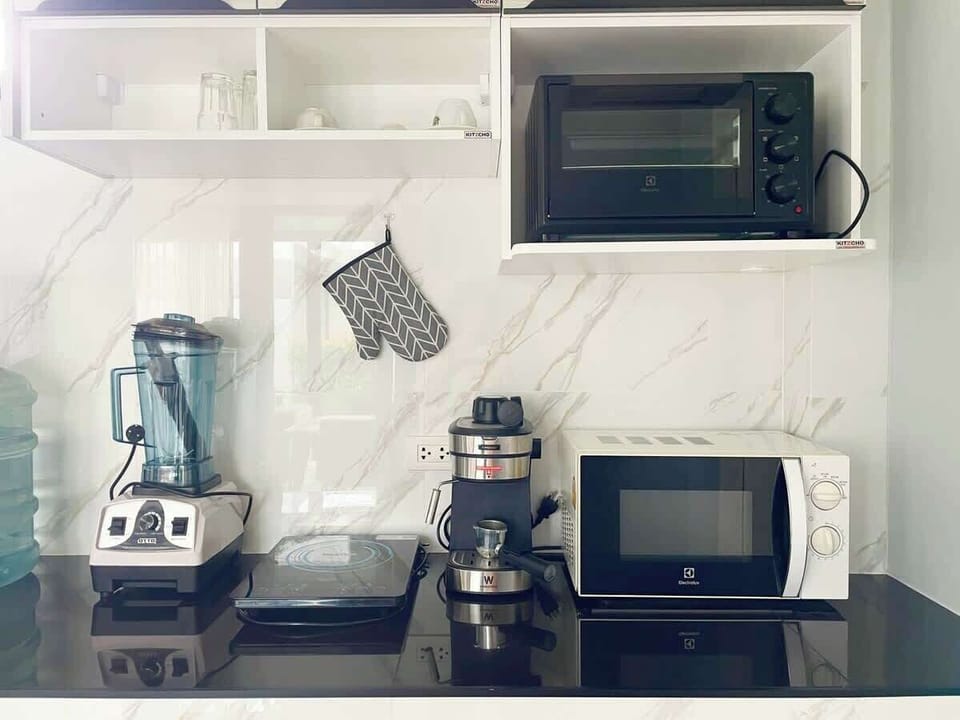 Kitchen equipped with Blender, Induction Hob, Espresso Coffee Machine, Air Fryer, Countertop Oven and Microwave Oven