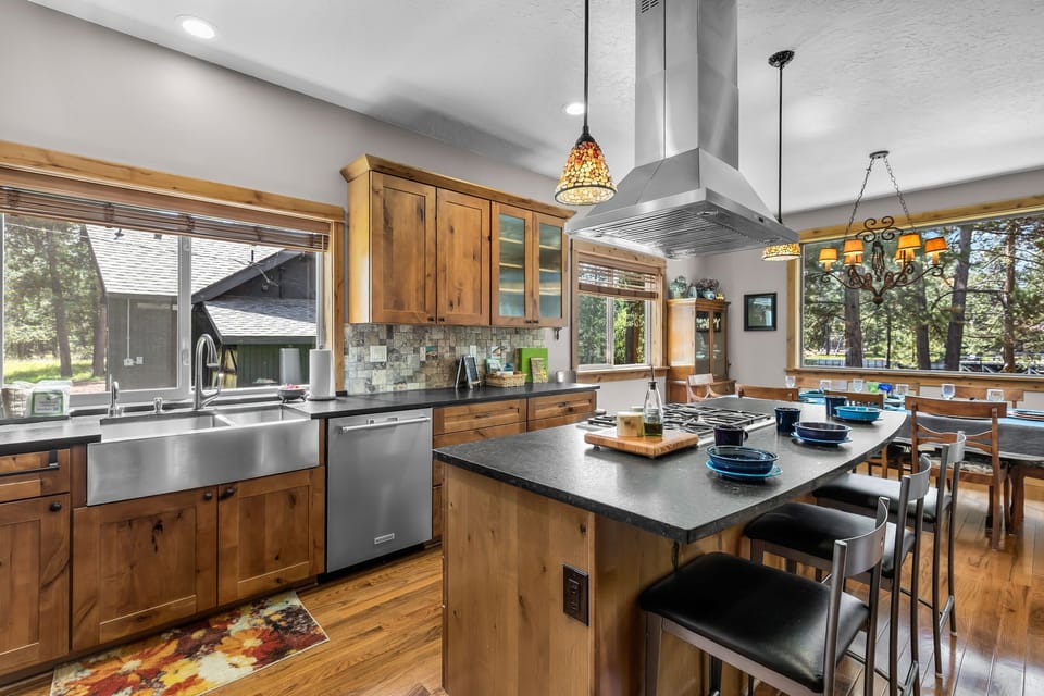 Gather around this spacious island where meals become memories. Warm wood tones, modern appliances, and natural light create your perfect culinary retreat.