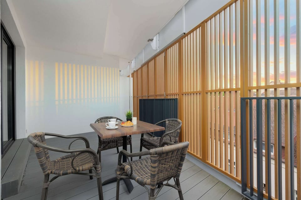 Another balcony seating arrangement with modern furniture. It offers a pleasant outdoor relaxation area.