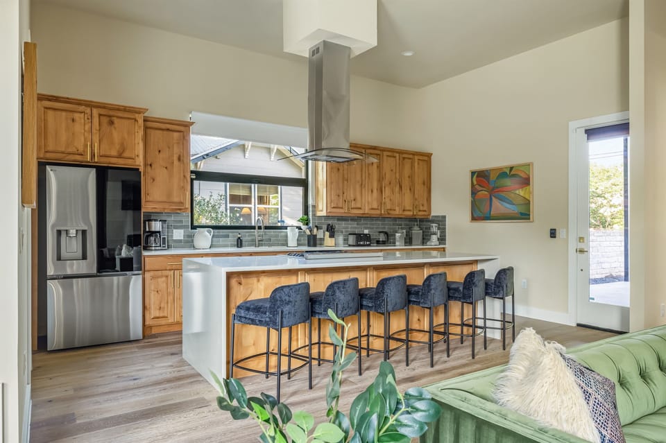 Spacious open-concept kitchen featuring a large island with bar seating, modern appliances, and plenty of room for cooking, dining, and gathering together.