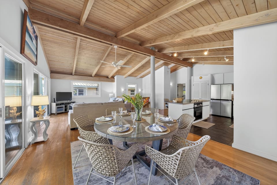 Gather for meals in the airy dining space beside the open-concept kitchen.