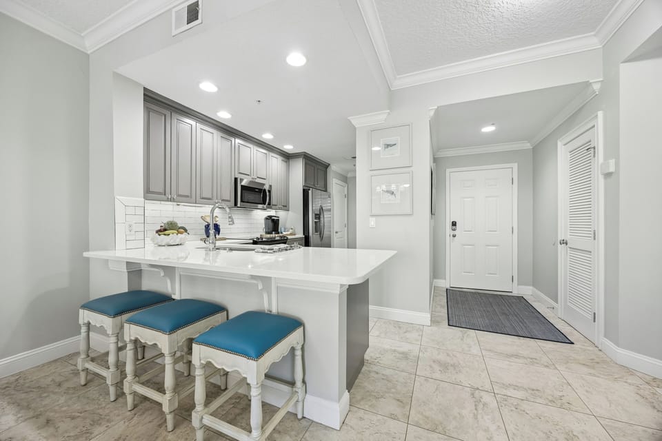 Step into your bright, welcoming retreat with a modern kitchen featuring gleaming countertops, stainless appliances, and a cozy breakfast bar—perfect for your morning coffee or evening wine.