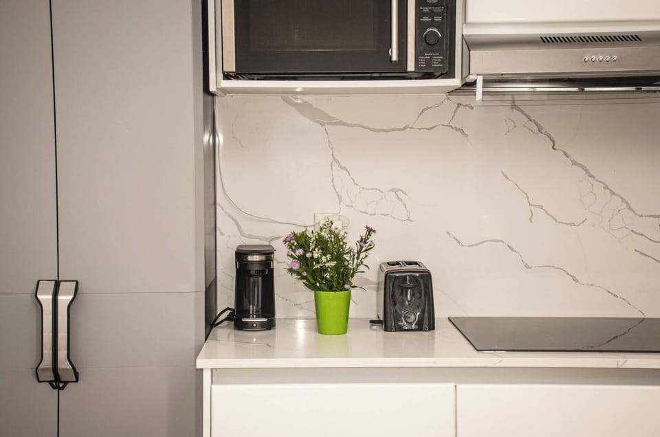 It has a coffee maker, toaster, microwave oven, blender and a 4-burner electric grill.
