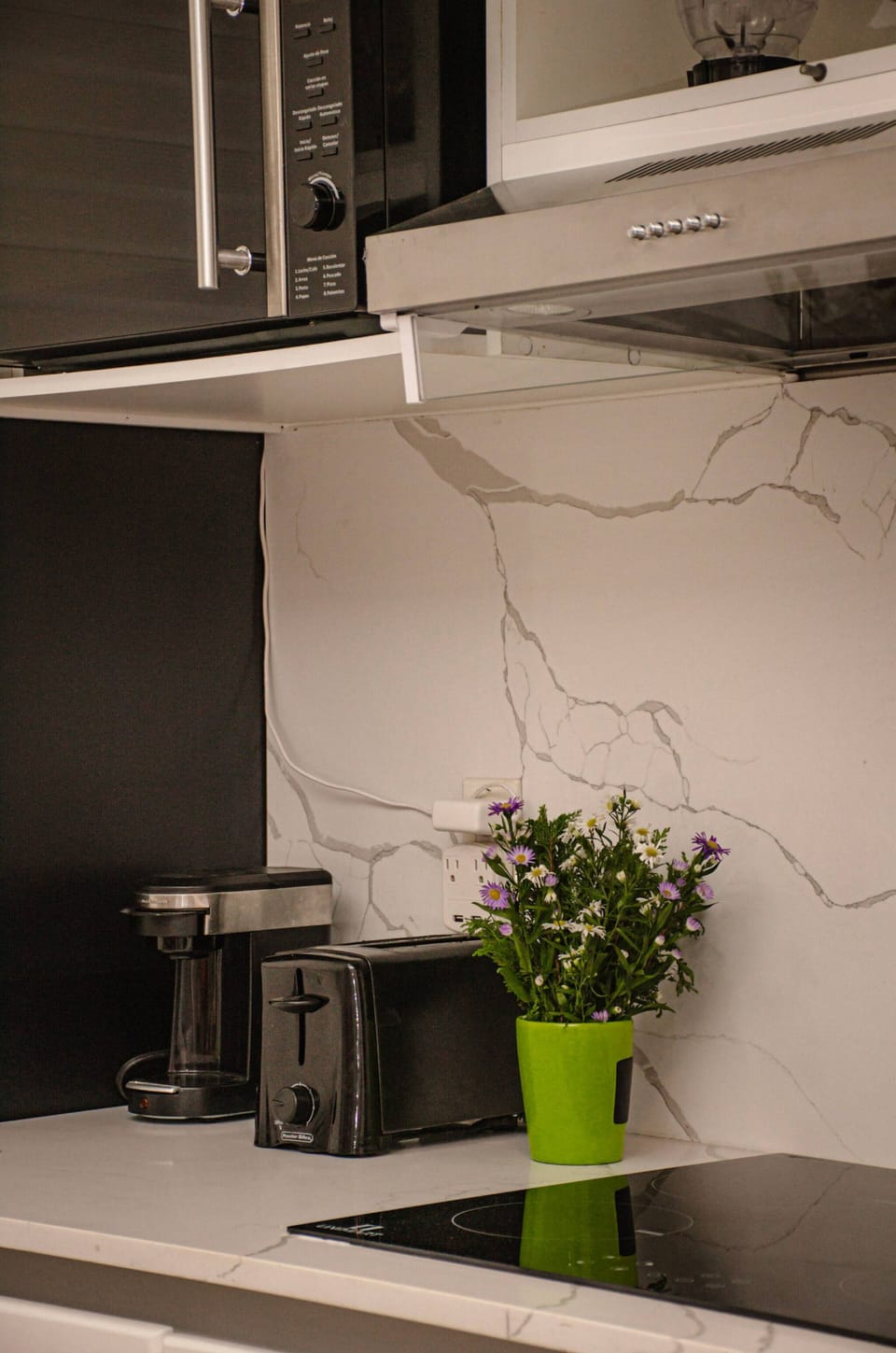 Kitchen with coffee maker, toaster and blender.