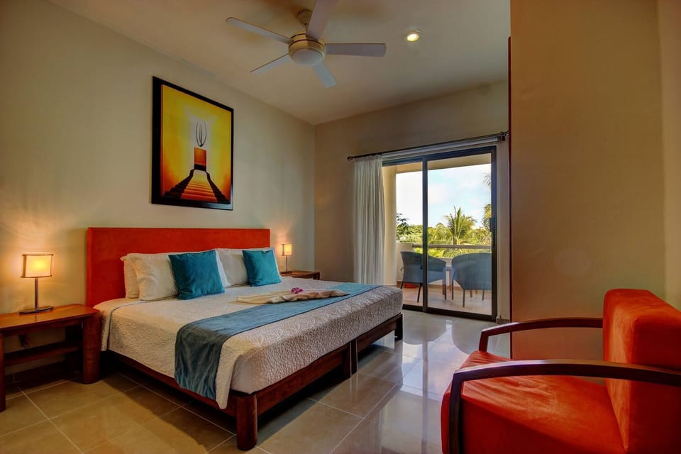 Master bedroom with king-size bed, closet, and balcony overlooking the pool and garden.
