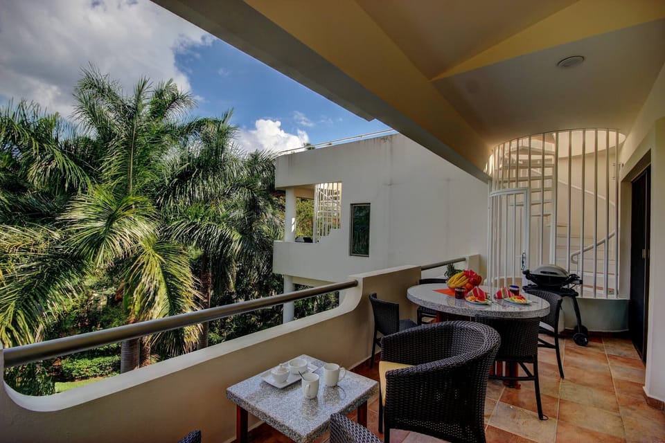 Large balcony with beautiful views of the pool and tropical garden.