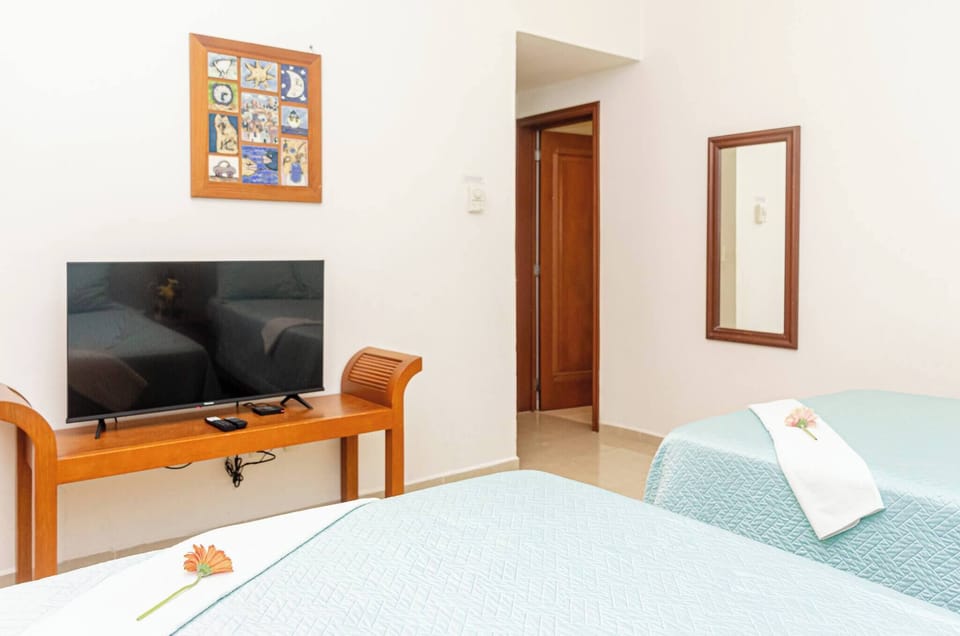 The second bedroom has 2 double beds and a full bathroom with amenities.