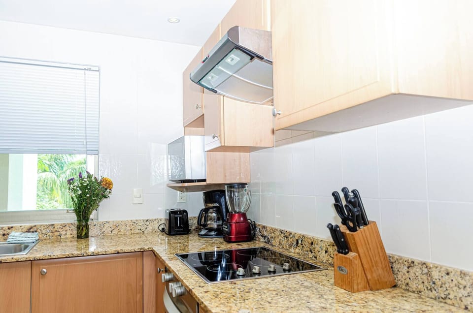 With utensils and a dishwasher. A 4-burner electric grill and a large refrigerator.