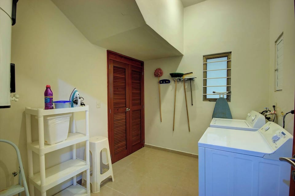 Laundry room with washer, dryer, cleaning products, and an iron for free use during your stay.