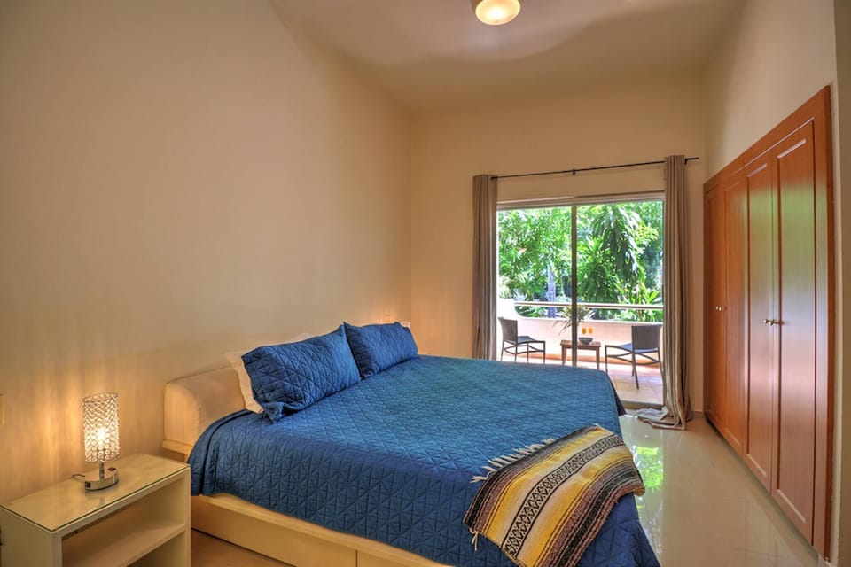 Master bedroom with king-size bed, TV,closet and full bathroom