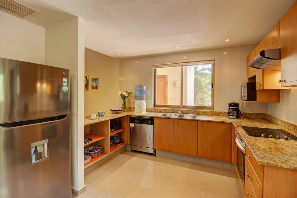 Large kitchen with a fully equipped refrigerator and dishwasher.
