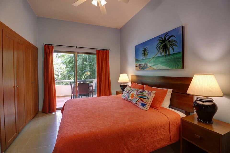 Master bedroom with king-size bed, closet, and TV