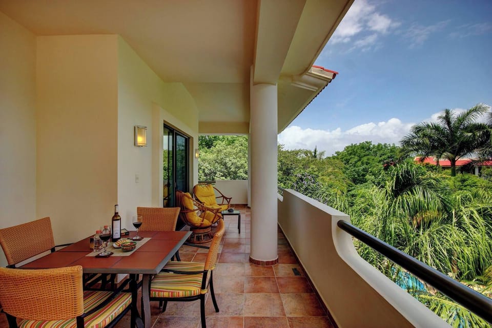 Large balcony with a nice view of the garden and pool