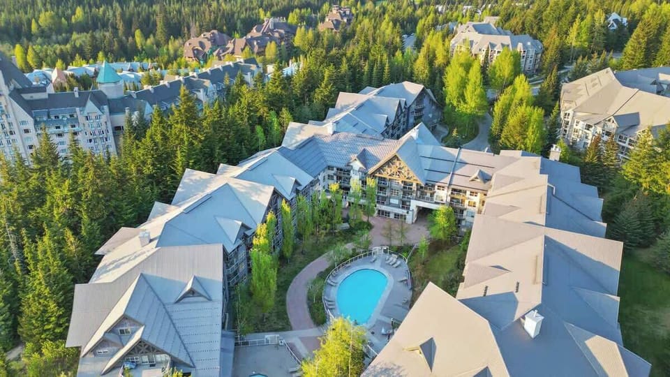 Aerial view of complex with a communal outdoor pool 
