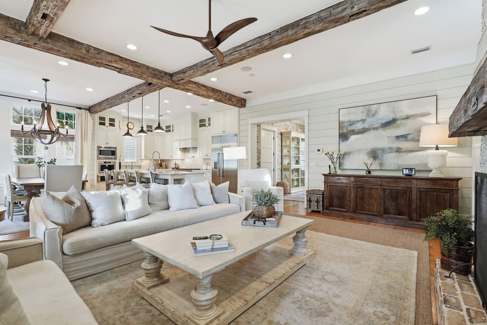 Gather with loved ones in this open-concept living space, where rustic beams and farmhouse elegance create a warm, inviting retreat for your stay.