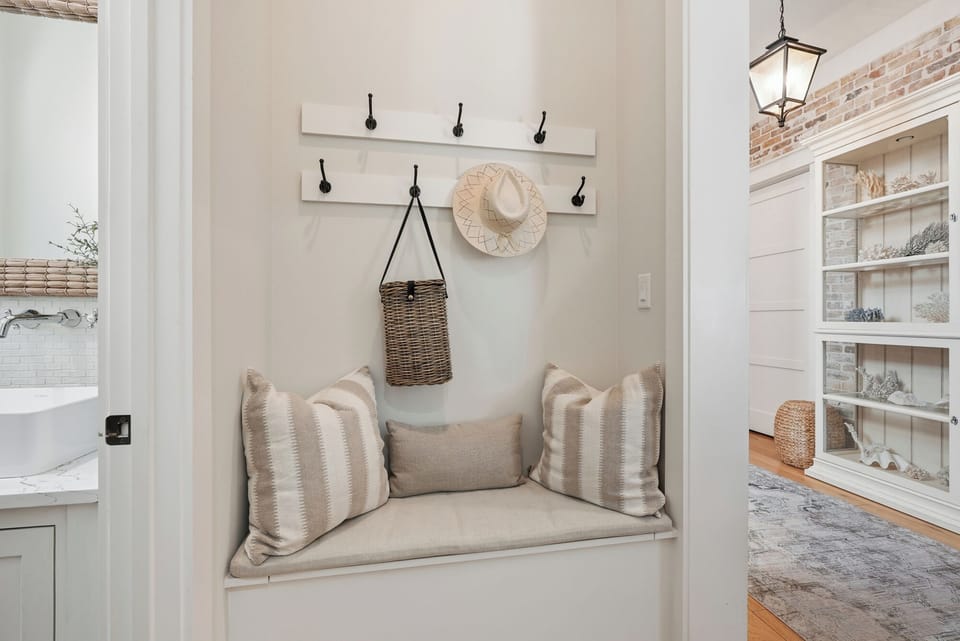 Settle into this cozy nook with soft cushions, perfect for curling up with a book or sipping morning coffee. The built-in bench and warm coastal touches create your personal hideaway.