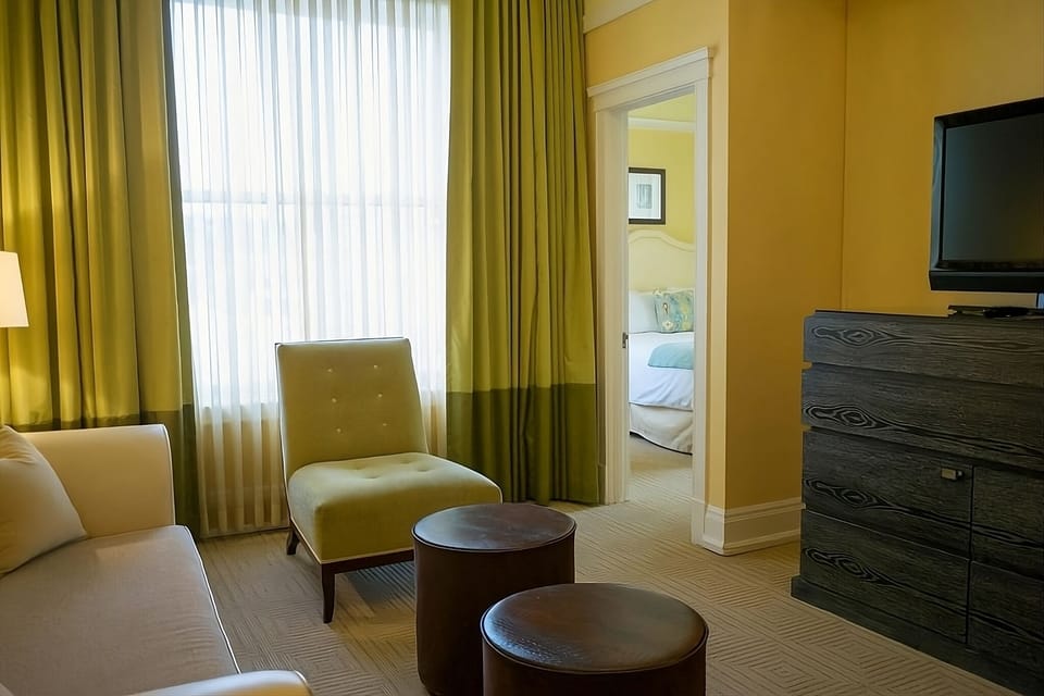 Sip coffee in the sitting area beside tall, bright windows.