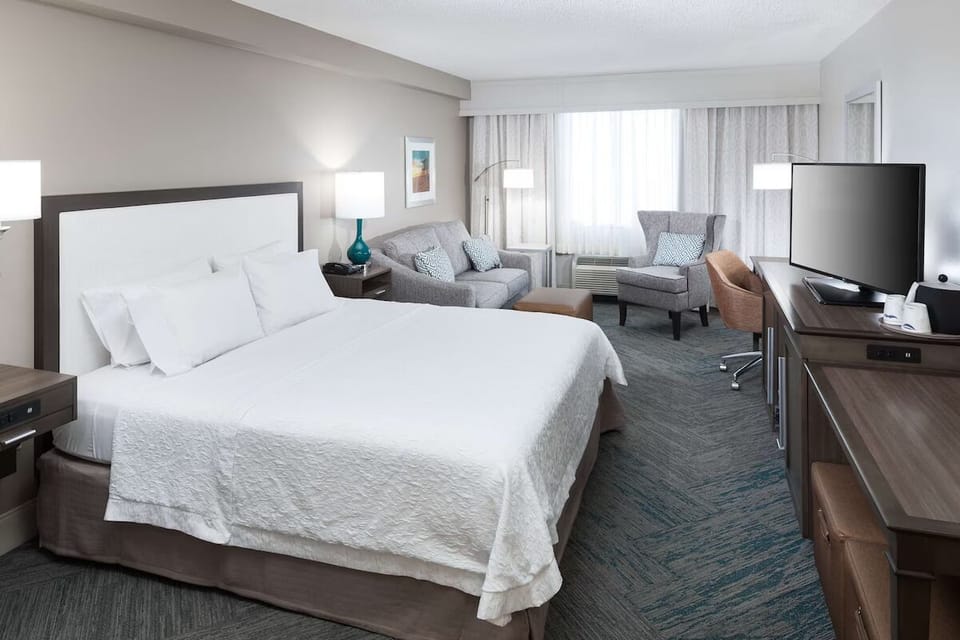 Unwind in a bright king room with cozy seating.