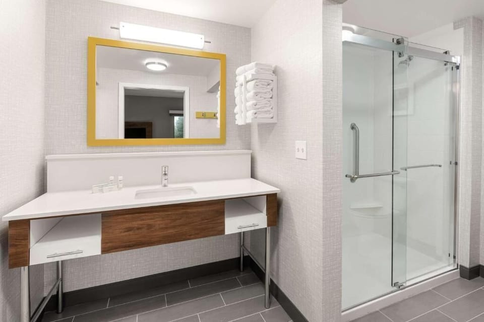 Freshen up at the sleek vanity with bright, flattering light.