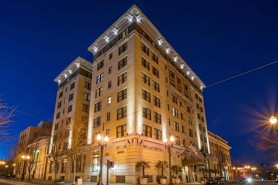 Arrive to a beautifully lit landmark façade at dusk.