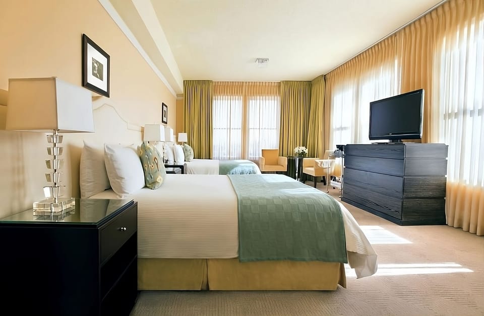 Wake up in a sunlit suite with lounge seating and TV.