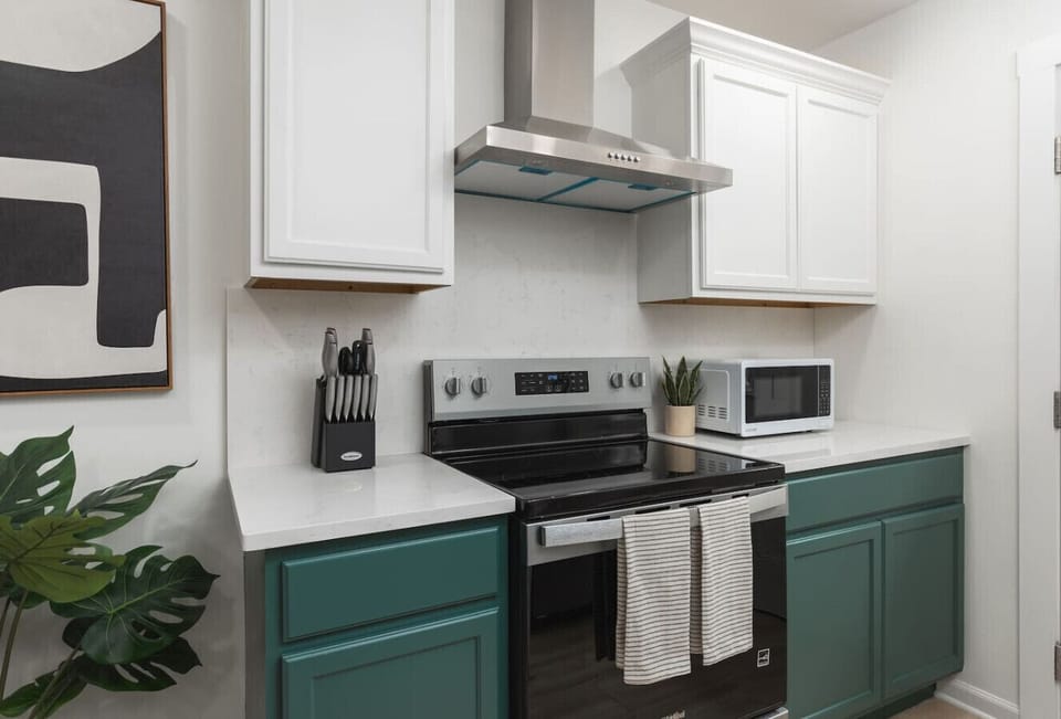 Fully equipped kitchen with all your cooking essentials, drip coffee maker + coffee. This room opens up into the dining area with seating for 5, and into the living room.