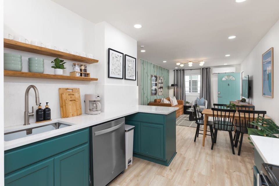 Fully equipped kitchen with all your cooking essentials, drip coffee maker + coffee. This room opens up into the dining area with seating for 5, and into the living room.
